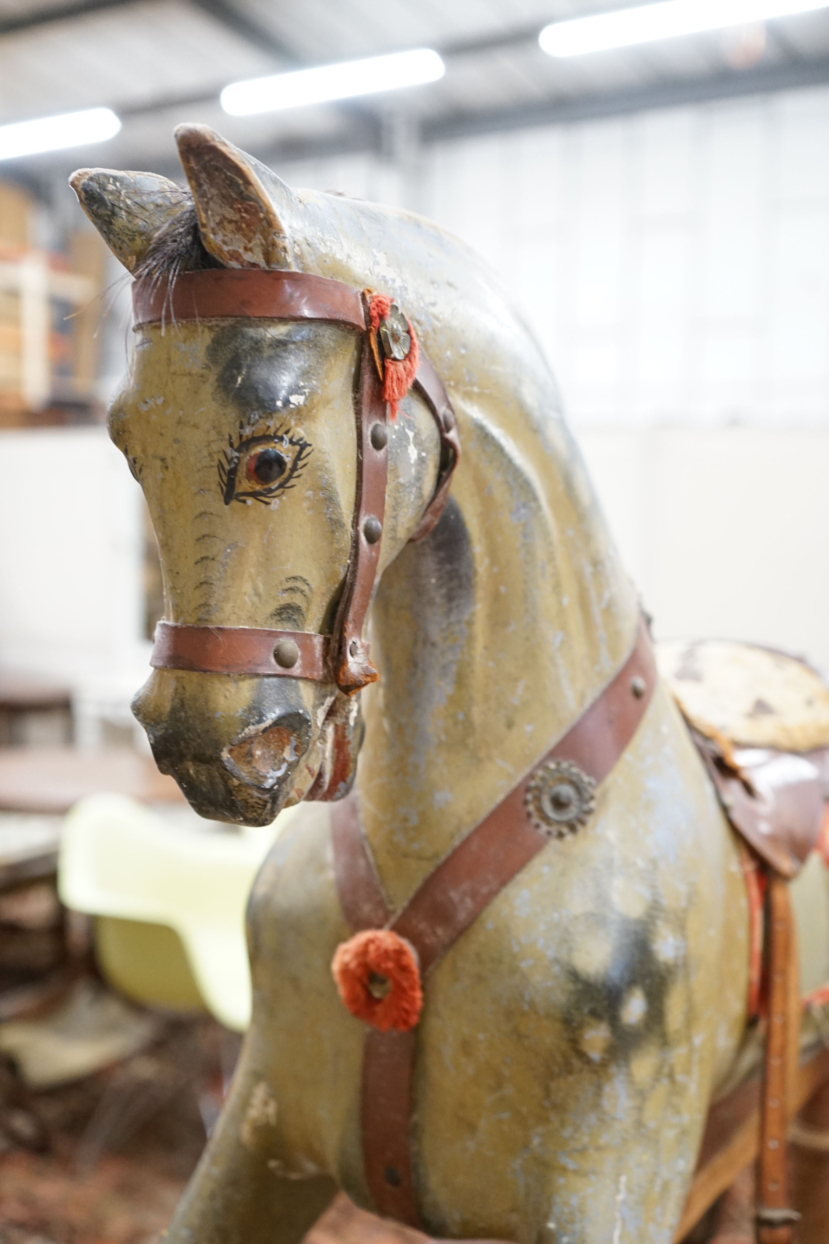 An Edwardian carved wood and dapple painted rocking horse, raised in a trestle frame, length 127cm, height 95cm